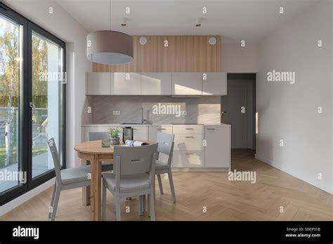 Interior of a modern apartment with a kitchenette and dining area