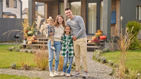 Ilustračná fotografia šťastnej rodiny pred novým domom.