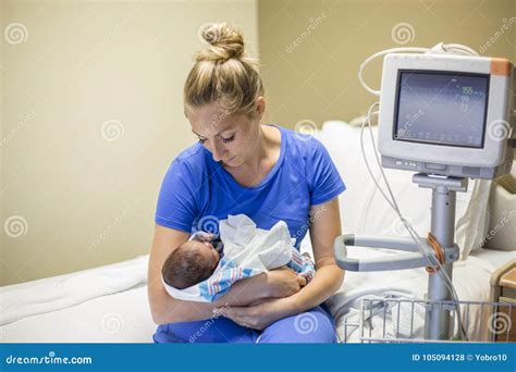 mother holding premature baby