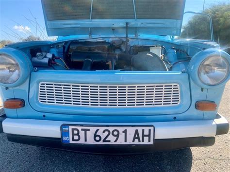 Auto s otvorenou kapotou a mechanikom