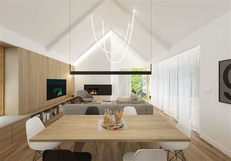 Interiér obývačky s vysokým stropom a výhľadom do lesa.